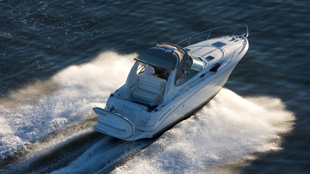 White power boat seen from above at speed